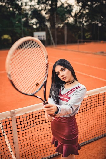 Woman in Grey and Red Long-sleeved Shirt Holding Tennis Racket