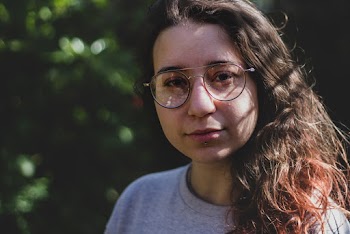 Woman in Grey Crew Neck Shirt and Black Framed Eyeglasses