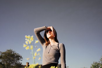 Woman in Grey Henley Long-sleeved Shirt Near Yellow Flower
