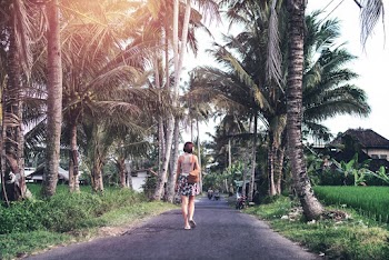 Woman in Grey Tank Top Walking at the Road