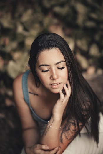 Woman in Grey Top Putting Hand on Her Face