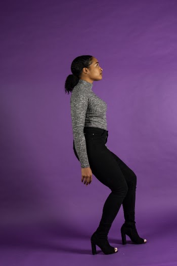 Woman in Grey Turtleneck and black Pants Posing