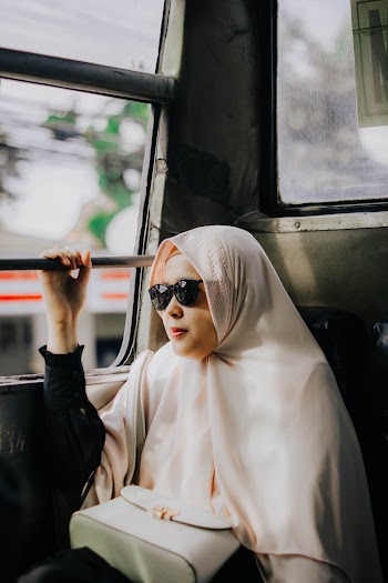 Woman In Hijab Seated By the Window