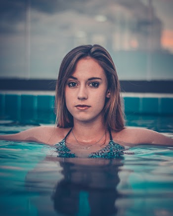 Woman in In-ground Pool Looking at Camera