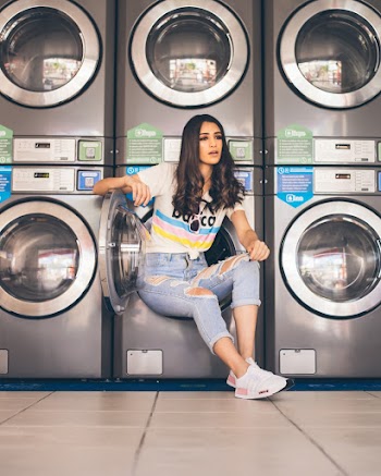 Woman in Jeans Sitting on Washer