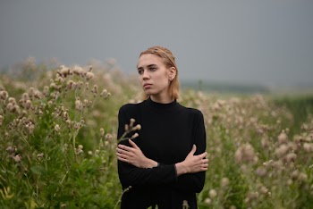 Woman in Long-sleeved Top on Flower Field