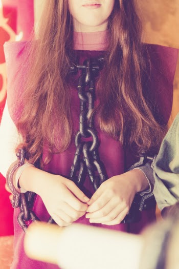 Woman in Maroon Shirt With Black Chain on Her Body