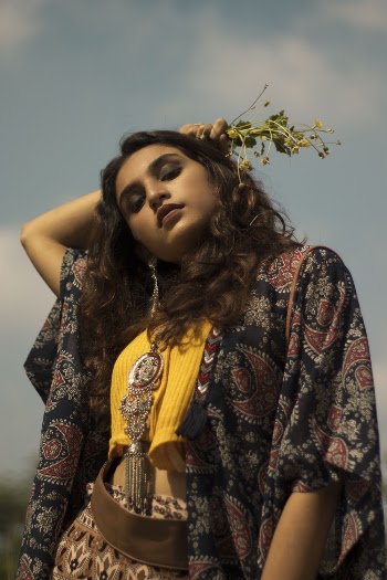 Woman in Multicolored Floral Coat While Holding Plant