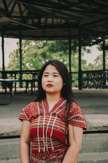 Woman in Multicolored Traditional Dress in Front of Gazebo