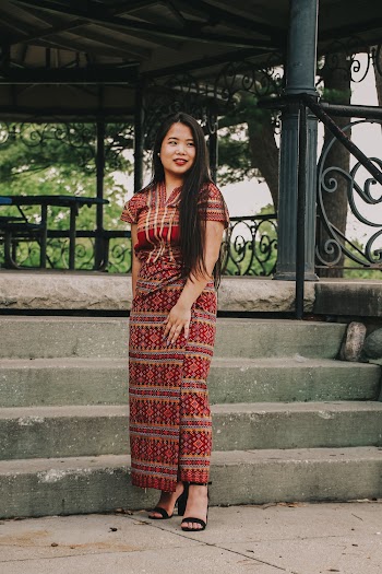 Woman in Multicolored Traditional Dress Standing in Front of Gazebo