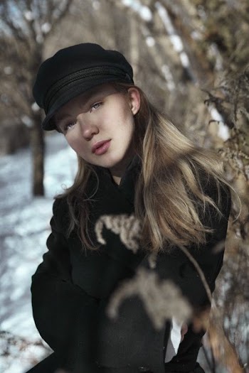 Woman In Newsboy Cap In Woods