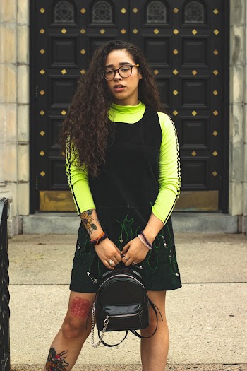 Woman In Olive Green Shirt Standing Near Door