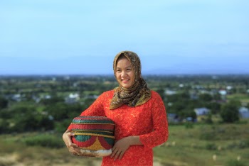 Woman In Orange Dress Holding A Basket