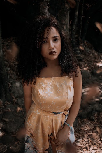 Woman in Orange Floral Dress Posing