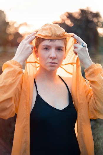 Woman in Orange Raincoat
