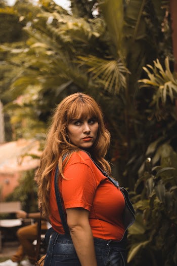 Woman In Orange T-shirt And Blue Denim Overalls