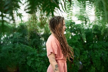 Woman in Peach-colored Dress by Plants
