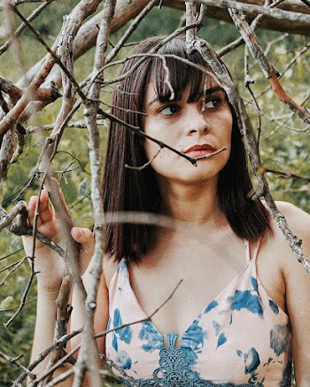 Woman in Pink and Blue Floral Spaghetti Strap Top