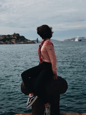 Woman in Pink and White Striped Sweater and Black Pants