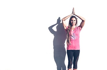 Woman in Pink Crew-neck T-shirt and Black Leggings Standing Near White Wall
