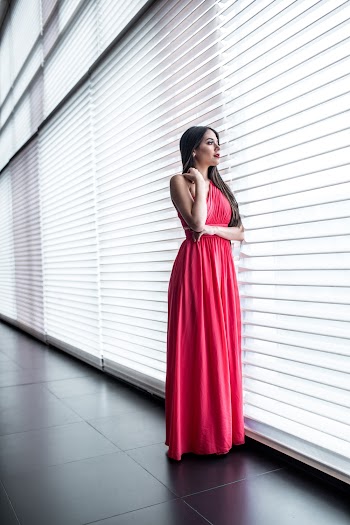 Woman in Pink Dress Standing Near Window
