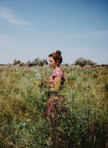 Woman in Pink Floral Dress Standing on Green Grass Field · Free Stock Photo