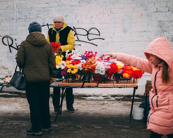 Woman in Pink Full-zip Hoodie Holding Multicolored Flowers