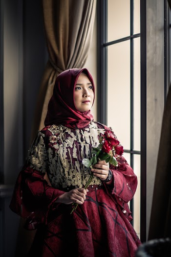 Woman in Pink Gown Holding Red Roses Indoors