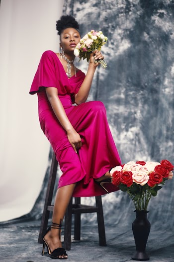 Woman in Pink Maxi Dress Holding Bouquet of Flowers
