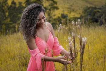 Woman in Pink Spaghetti Strap Dress Picking Flowers