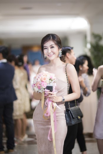 Woman in Pink Strapless Bodycon Dress Holding Flowers