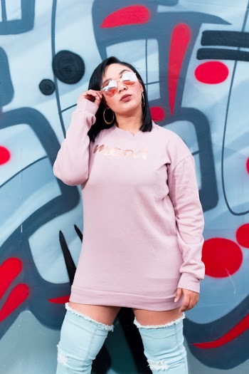 Woman in Pink Sweater Holding Sunglasses