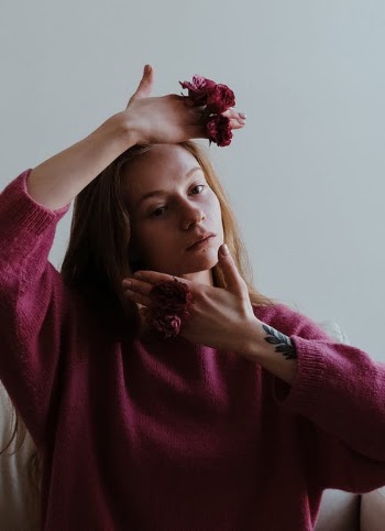 Woman in Pink Sweater With Red Flower on Her Ear · Free Stock Photo