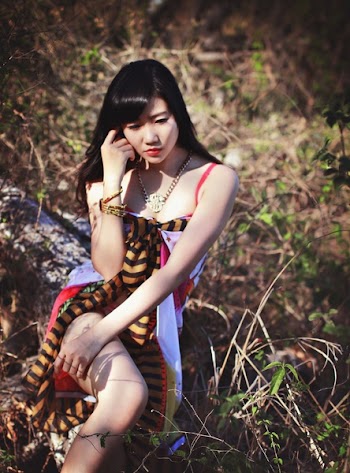 Woman in Pink White and Black Sleeveless Dress Posing for Photo