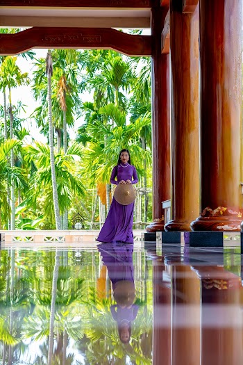 Woman In Purple Dress Standing Near Pillars