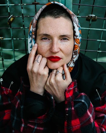 Woman In Re And Black Plaid Jacket