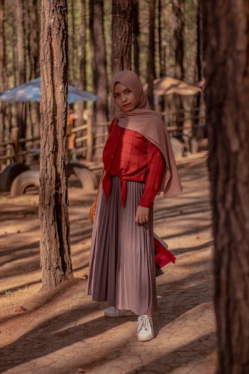 Woman in Red and Gray Dress Standing Beside Tree