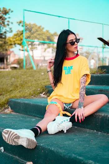 Woman in Red and Yellow T-shirt and White Sneakers