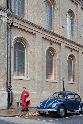 woman in red coat walking during daytime
