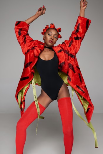 Woman in Red Coat Wearing Monokini and Red Stockings