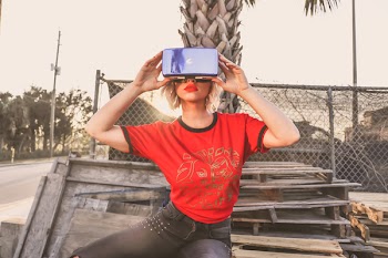 Woman in Red Crew-neck T-shirt Wearing Virtual Reality Glasses