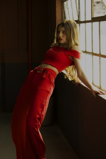 Woman In Red Crop Top and Red Pants