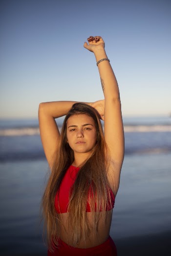 Woman in Red Crop Top Standing Near Beach
