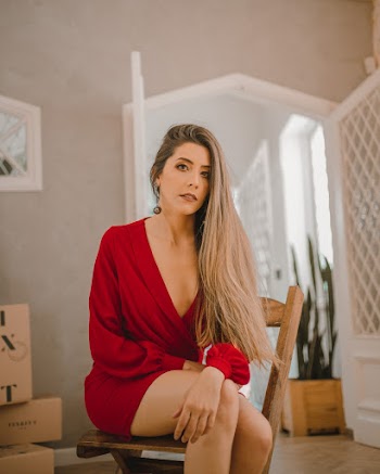 Woman In Red Dress Sitting On Chair