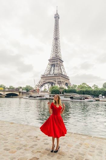 Woman in Red Dress Standing in Bank of River With the Eiffel Tower As Background