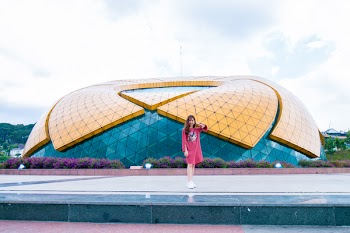 Woman in Red Dress Standing Near Stadium