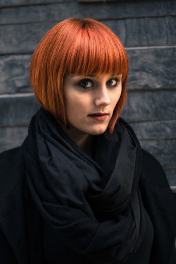 Woman in Red Hair and Black Coat