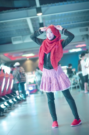 Woman in Red Head Scarf With Black Dress Shirt and Pink Skirt
