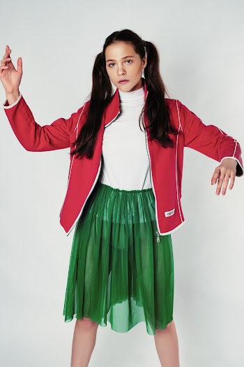 Woman in Red Jacket and Green Skirt