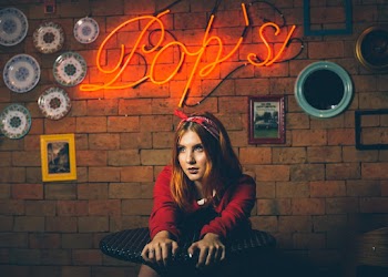 Woman in Red Jacket Near Wall